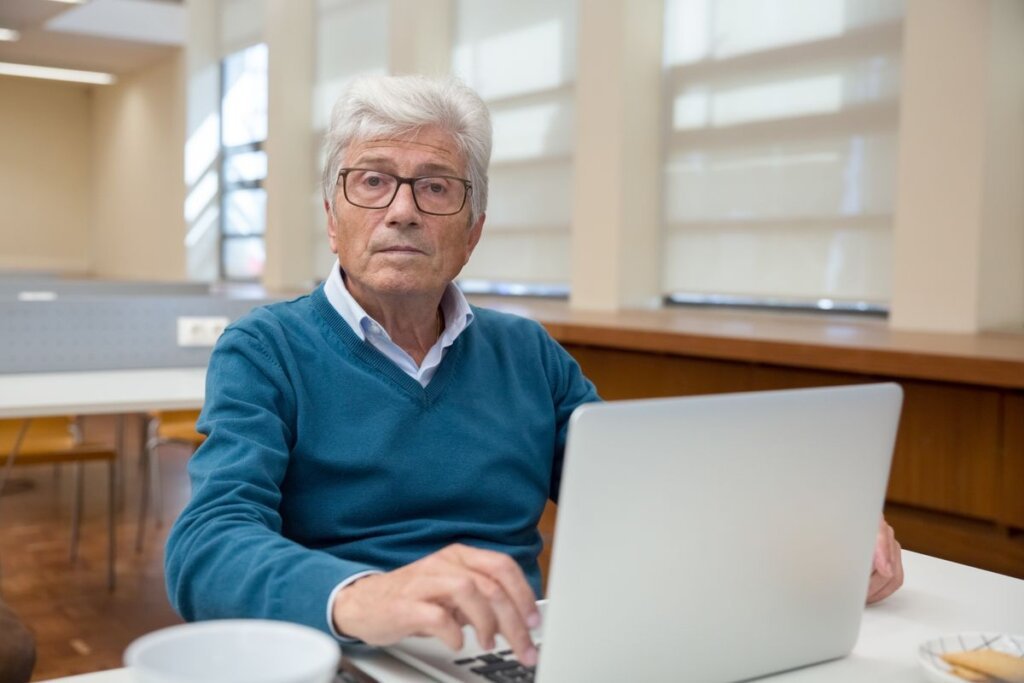 Senior man working on a laptop, showing that adults keep learning and changing at any age